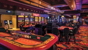 A casino floor with blackjack tables, slot machines, and an ATM. - Isle Casino Hotel Lula Hotel & Casino - A Caesars Rewards Destination (Lula)