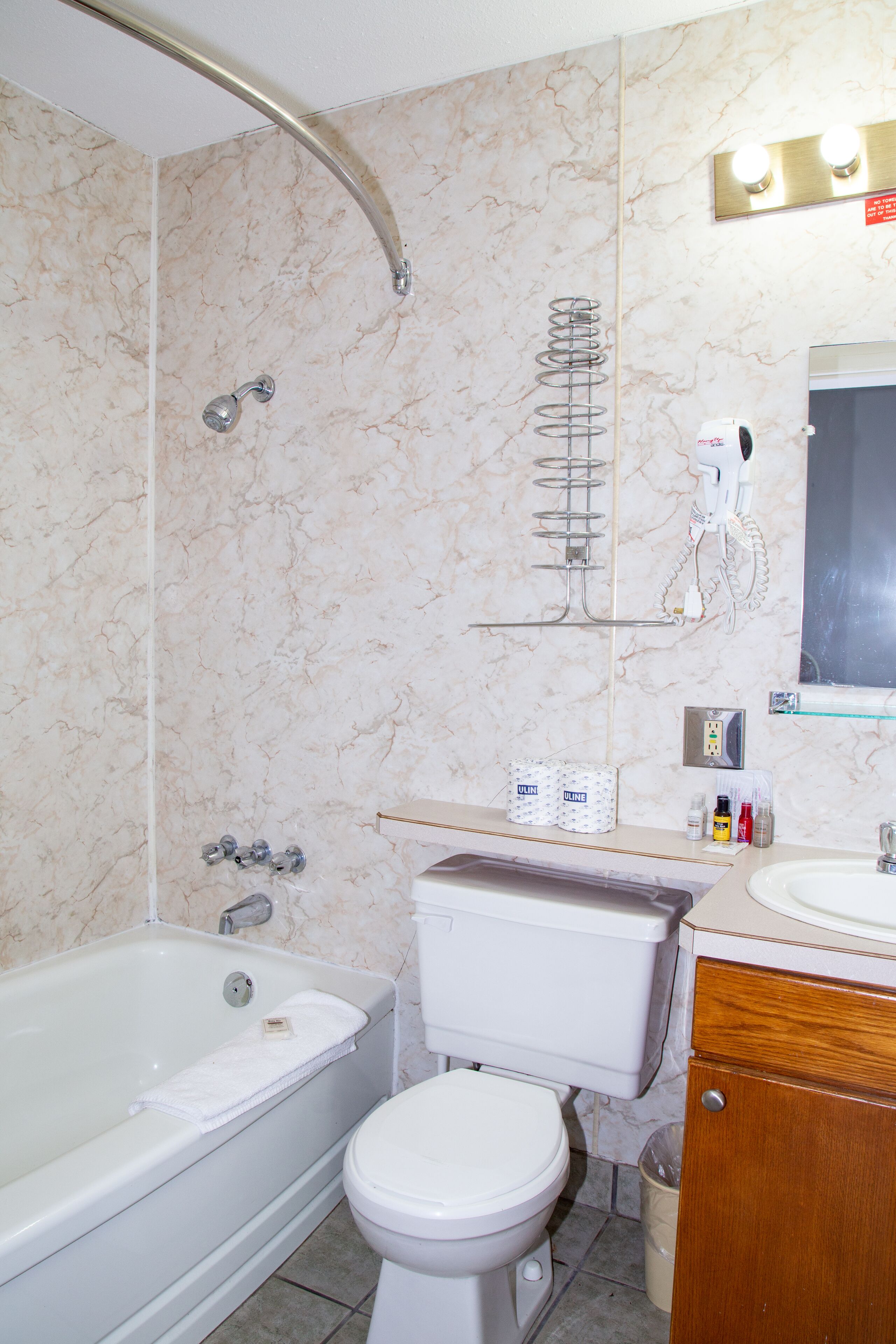A bathroom with a bathtub, toilet, and sink.