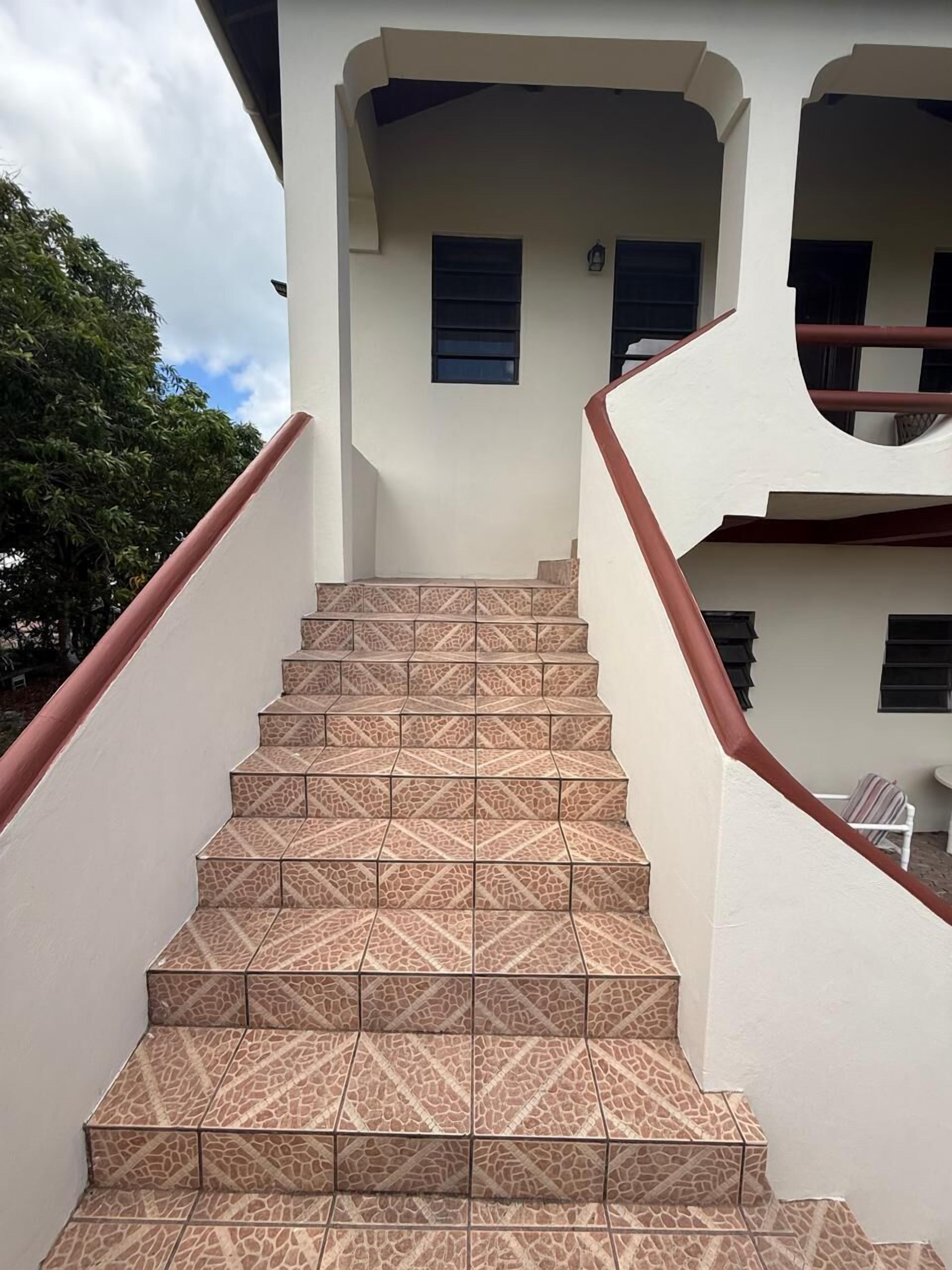 Una escalera con baldosas decoradas que lleva a la entrada de un edificio.