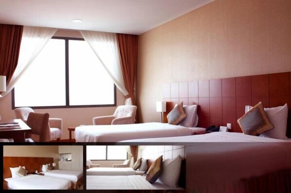 A hotel room with two beds, a desk, and a chair. - Aurora Hotel Plaza (Tam Hiep)