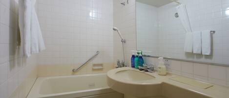 A bathroom with a bathtub, a sink, and a shower. There are toiletries on the sink counter.