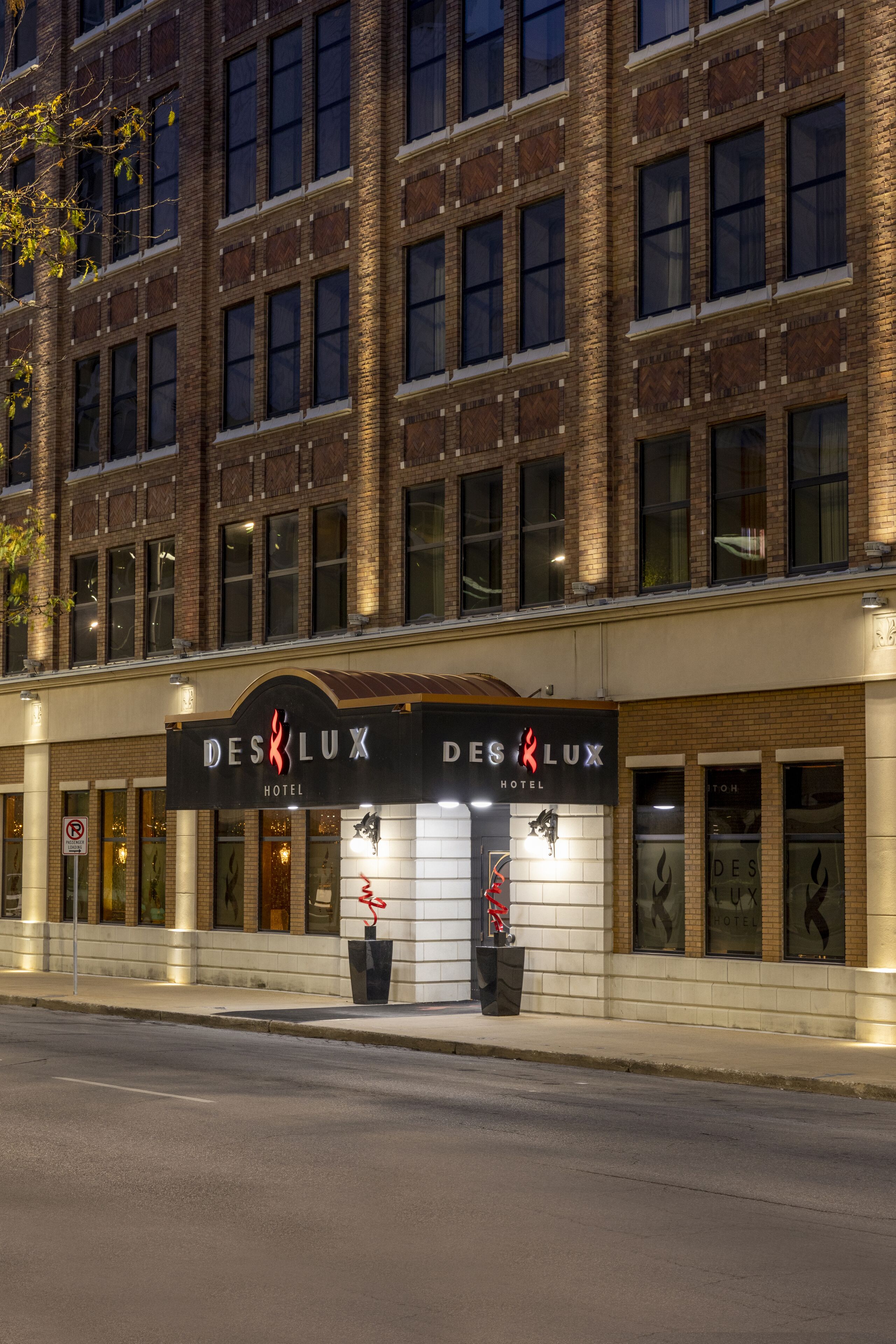 A hotel facade with a prominent sign reading "DESK LUX HOTEL".