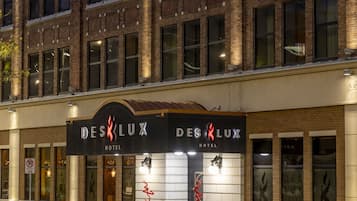 A hotel facade with a prominent sign reading "DESK LUX HOTEL".
