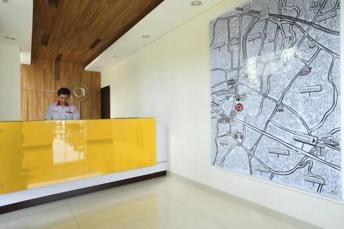 A reception area with a yellow counter, a large map on the wall, and a wooden ceiling.