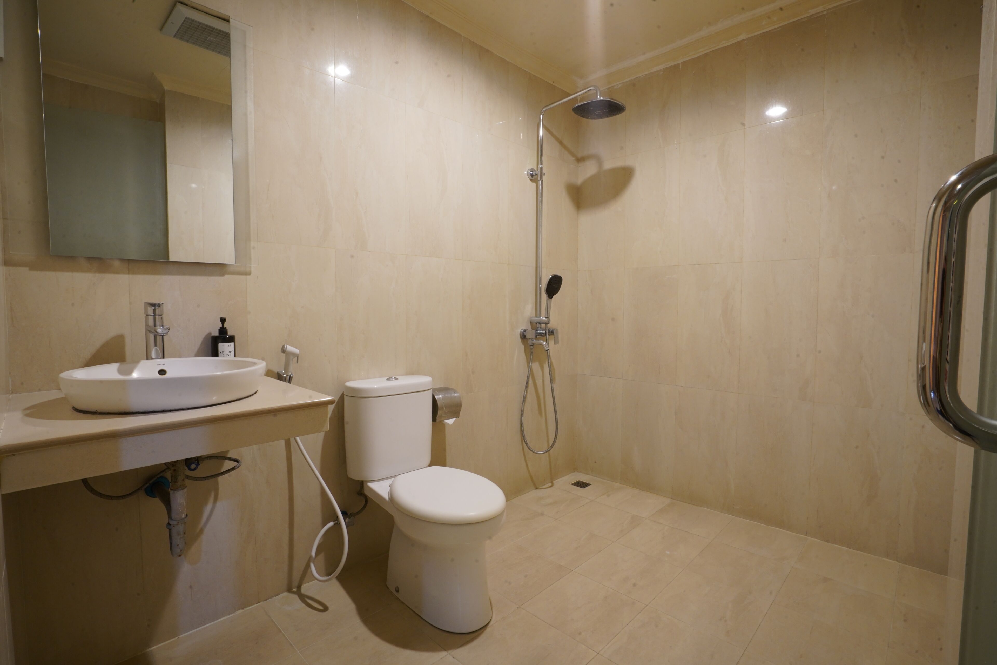 A bathroom with a sink, toilet, and shower.