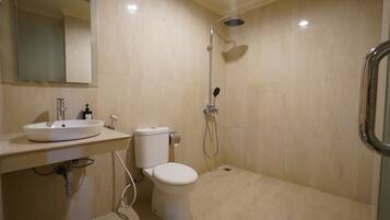 A bathroom with a sink, toilet, and shower.