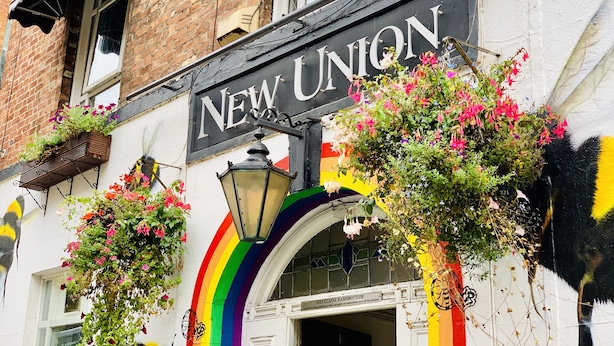 A building with a sign reading "NEW UNION" and a rainbow decoration. - New Union Hotel (Manchester)