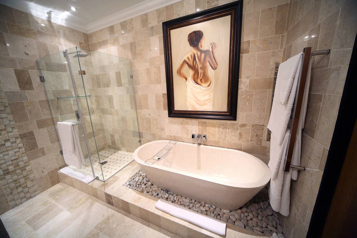 separate bathtub and shower, deep-soaking bathtub, rainfall showerhead