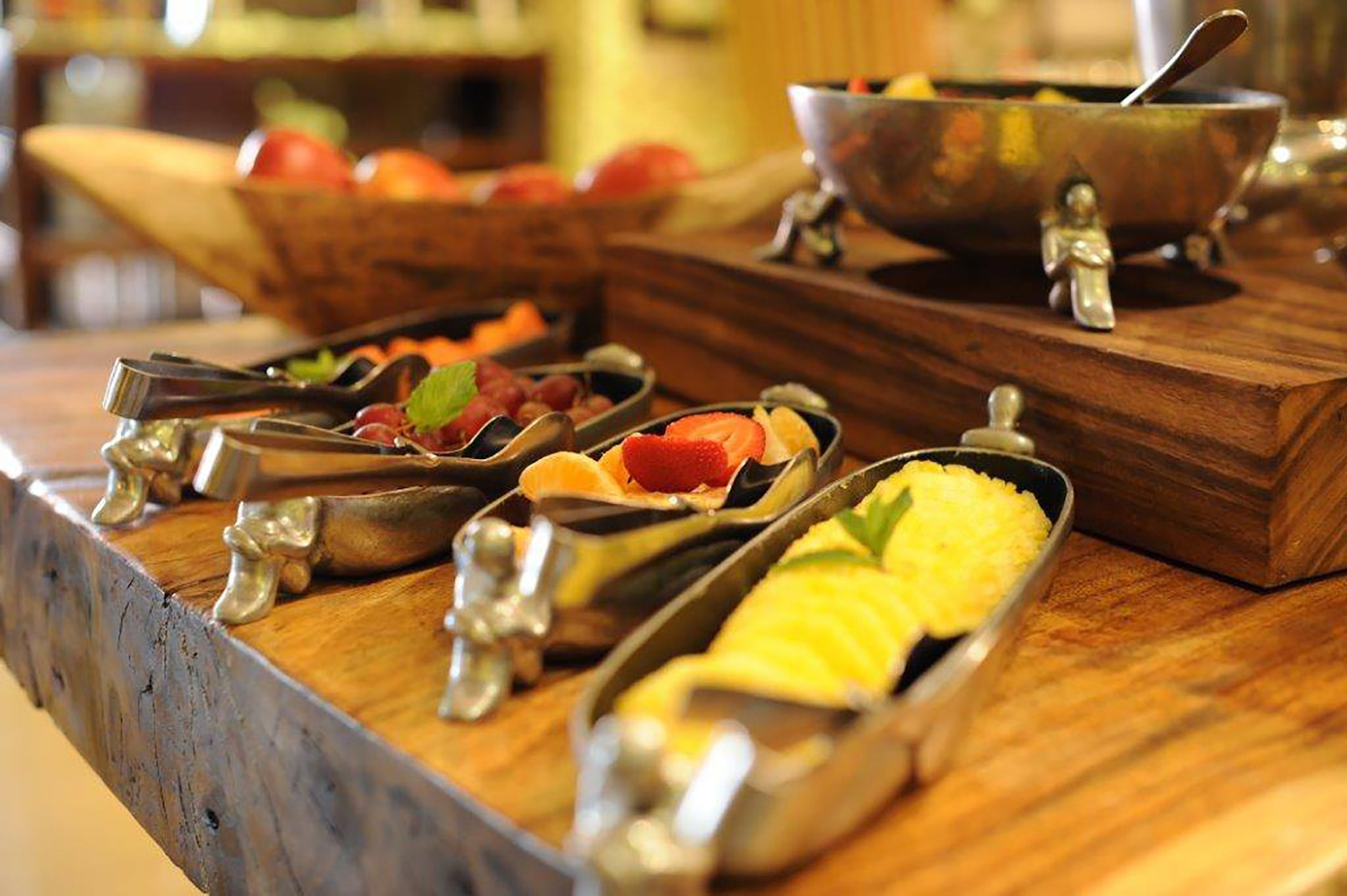 A buffet setup with various food items in metal serving trays.