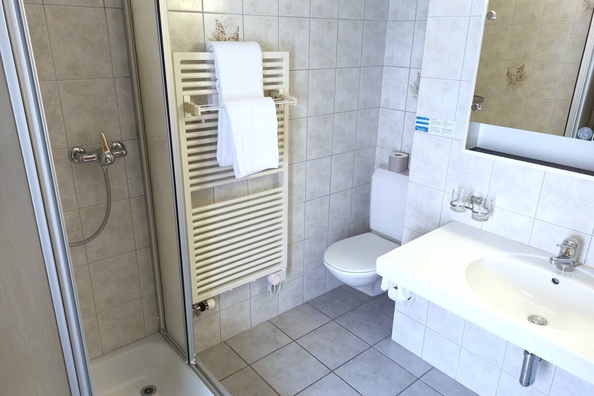 standard double room | bathroom | deep-soaking bathtub, rainfall showerhead, hair dryer, towels