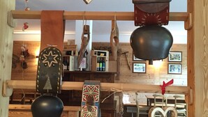 A rustic interior with wooden beams, hanging decorations, and a wooden bench. - ALBERGO ALPENROSE Ski&Bike Mountain Hotel (Gressoney-Saint-Jean)