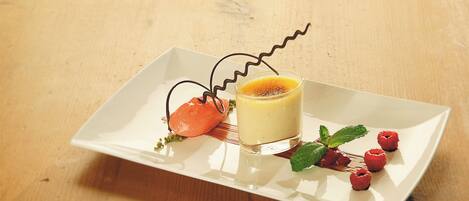 A dessert on a white rectangular plate with a wooden table background.