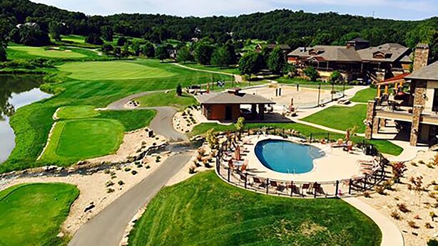 A golf course with a swimming pool and a clubhouse. - The Lodge at Old Kinderhook Golf Resort (Camdenton)