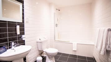 A modern bathroom with a white sink, toilet, and bathtub.