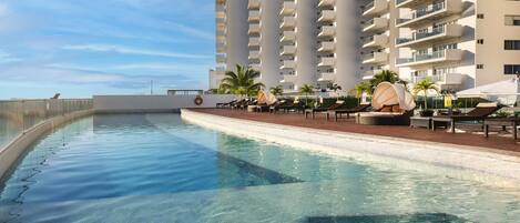 Outdoor pool, open 7:00 AM to 11:00 PM, pool umbrellas, sun loungers