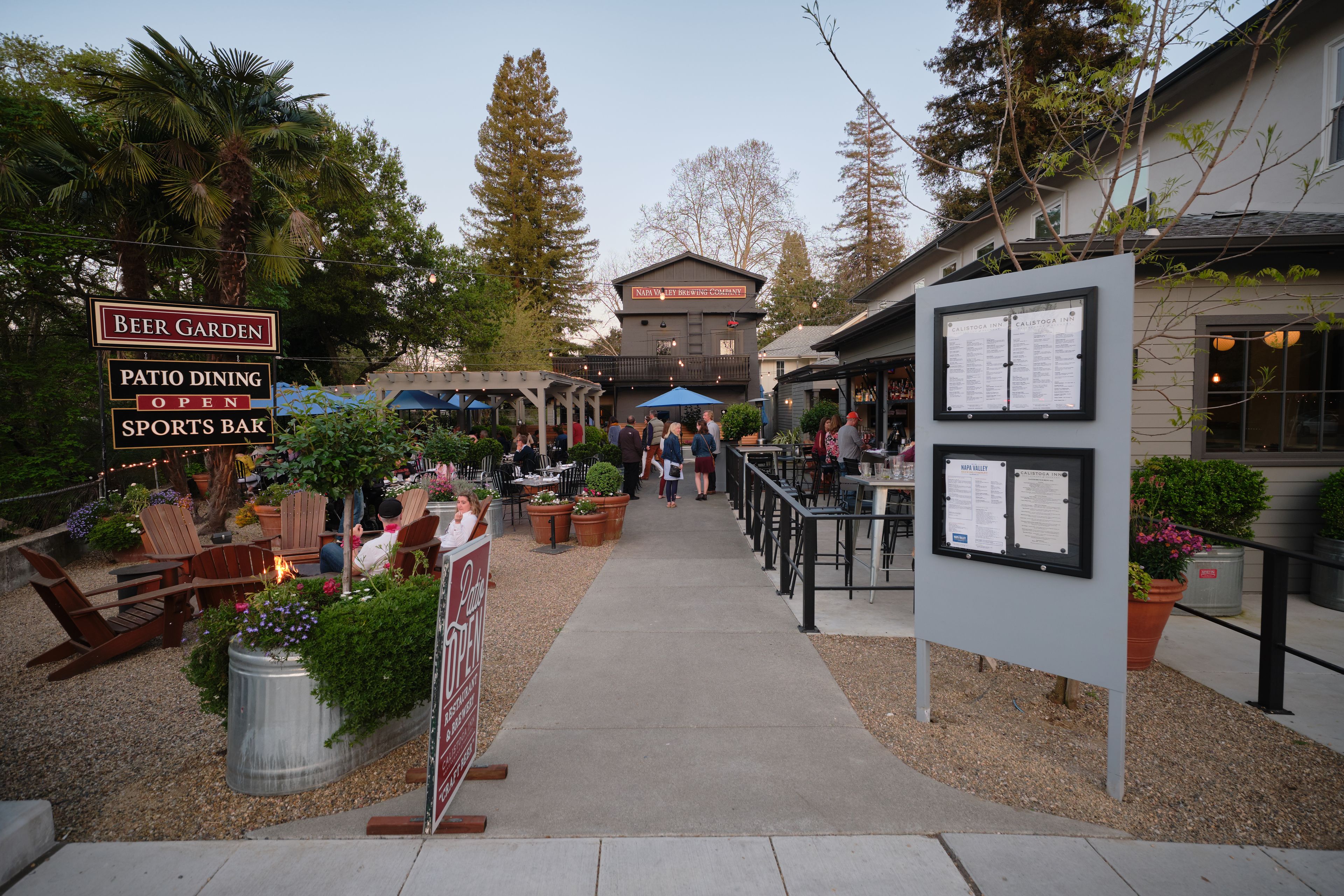 A patio area with outdoor seating, a sports bar, and a beer garden.