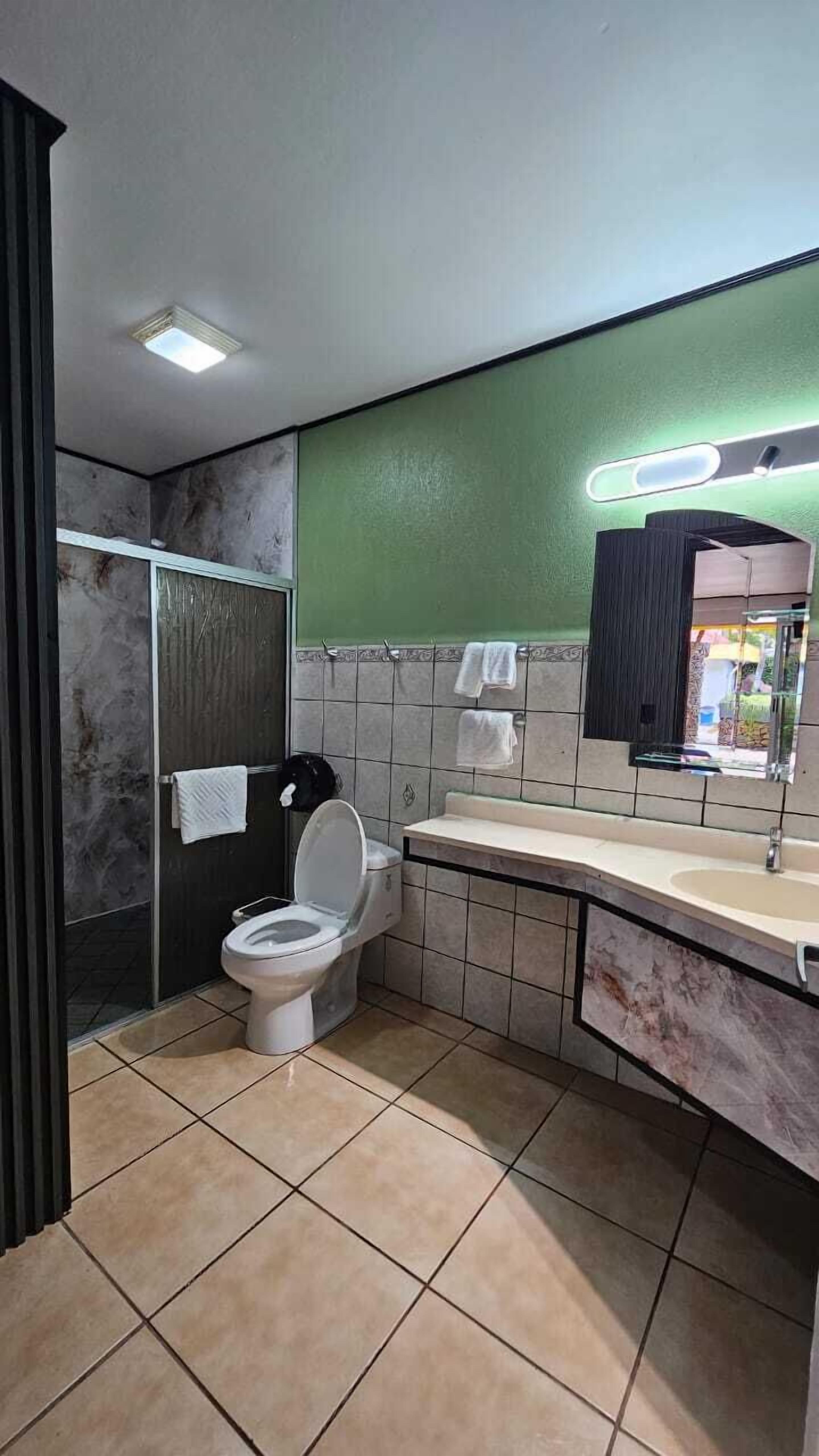 standard room, 2 double beds, pool view | bathroom | shower, free toiletries, hair dryer, towels