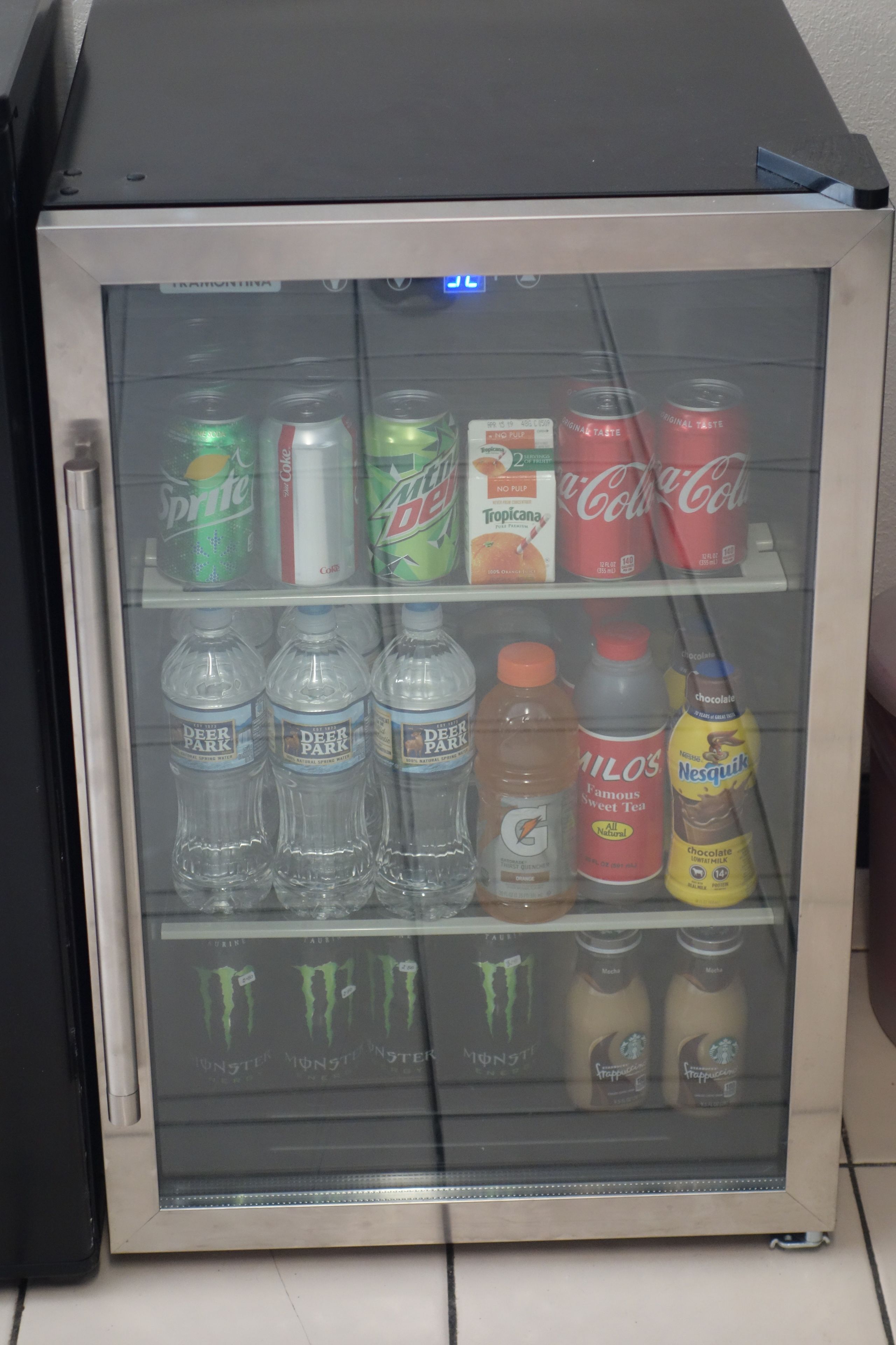 A beverage vending machine with various drinks including sodas, water, and energy drinks.