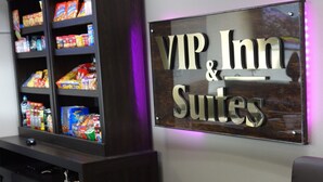 A sign for VIP & Suites with a snack display to the left. - VIP Inn and Suites (Huntsville)