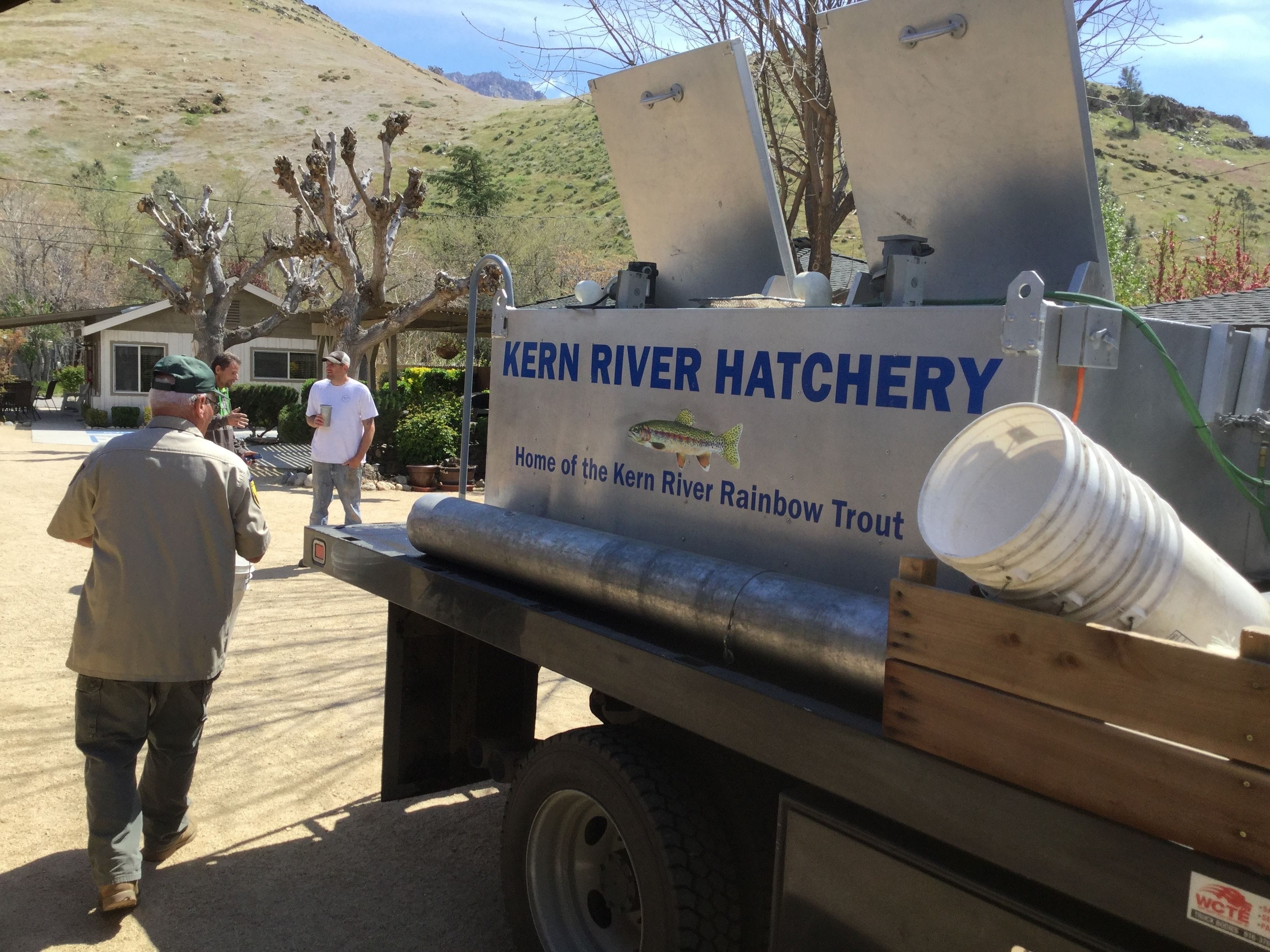 A hatchery sign with a rainbow trout illustration and the text "KERN RIVER HATCHERY Home of the Kern River Rainbow Trout".