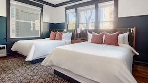 A hotel room with two beds, a patterned rug, and large windows with blinds. - The Davis Downtown San Diego (San Diego)