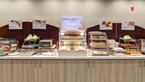A buffet counter with labeled sections for bread, eggs, fruit, and cereal. - Holiday Inn Express & Suites Oshawa Downtown - Toronto Area by IHG (Oshawa)