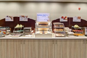 A buffet counter with labeled sections for bread, eggs, fruit, and cereal. - Holiday Inn Express & Suites Oshawa Downtown - Toronto Area by IHG (Oshawa)