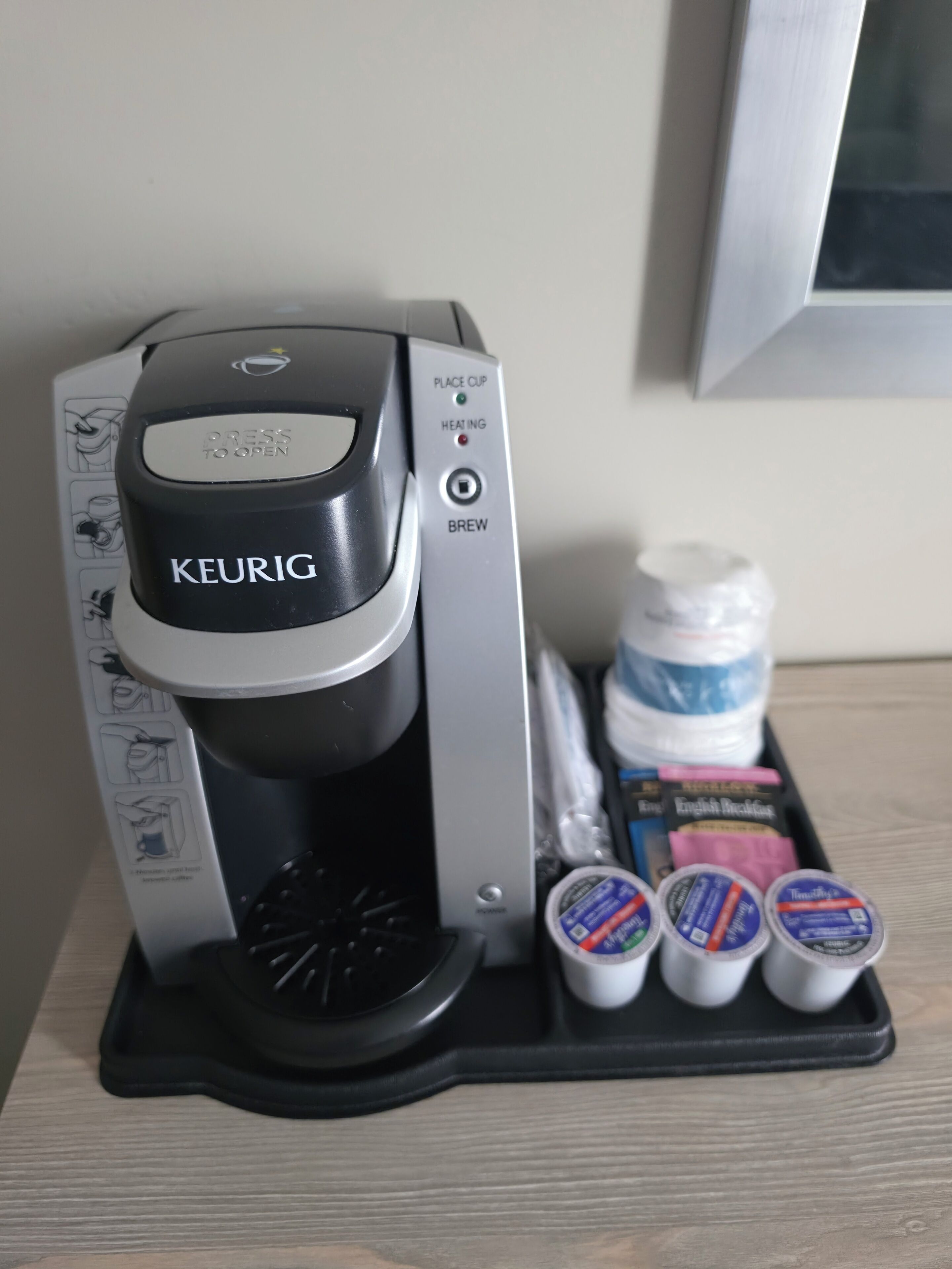 A Keurig coffee maker with a coffee pod holder containing multiple pods.