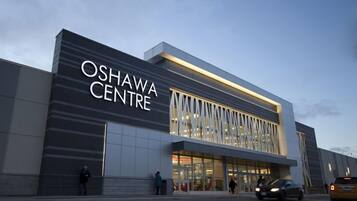 The Oshawa Centre building with a modern design, large glass windows, and a prominent sign.