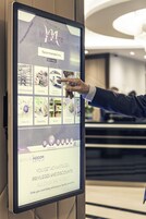 A digital display screen with hotel recommendations and amenities.