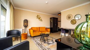 A modern living room with a sofa, chairs, a coffee table, and decorative wall art.