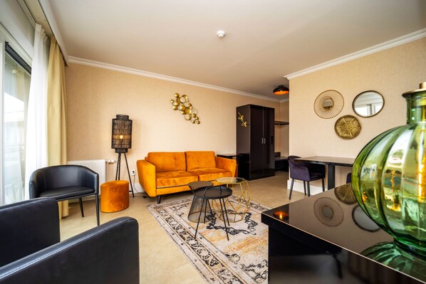 A modern living room with a sofa, chairs, a coffee table, and decorative wall art.