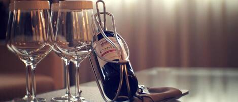 Three wine glasses on a tray, a bottle of wine, and a pair of shoes.