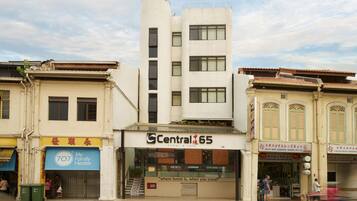A building with a sign for 'Central 65' indicating a hostel and cafe.