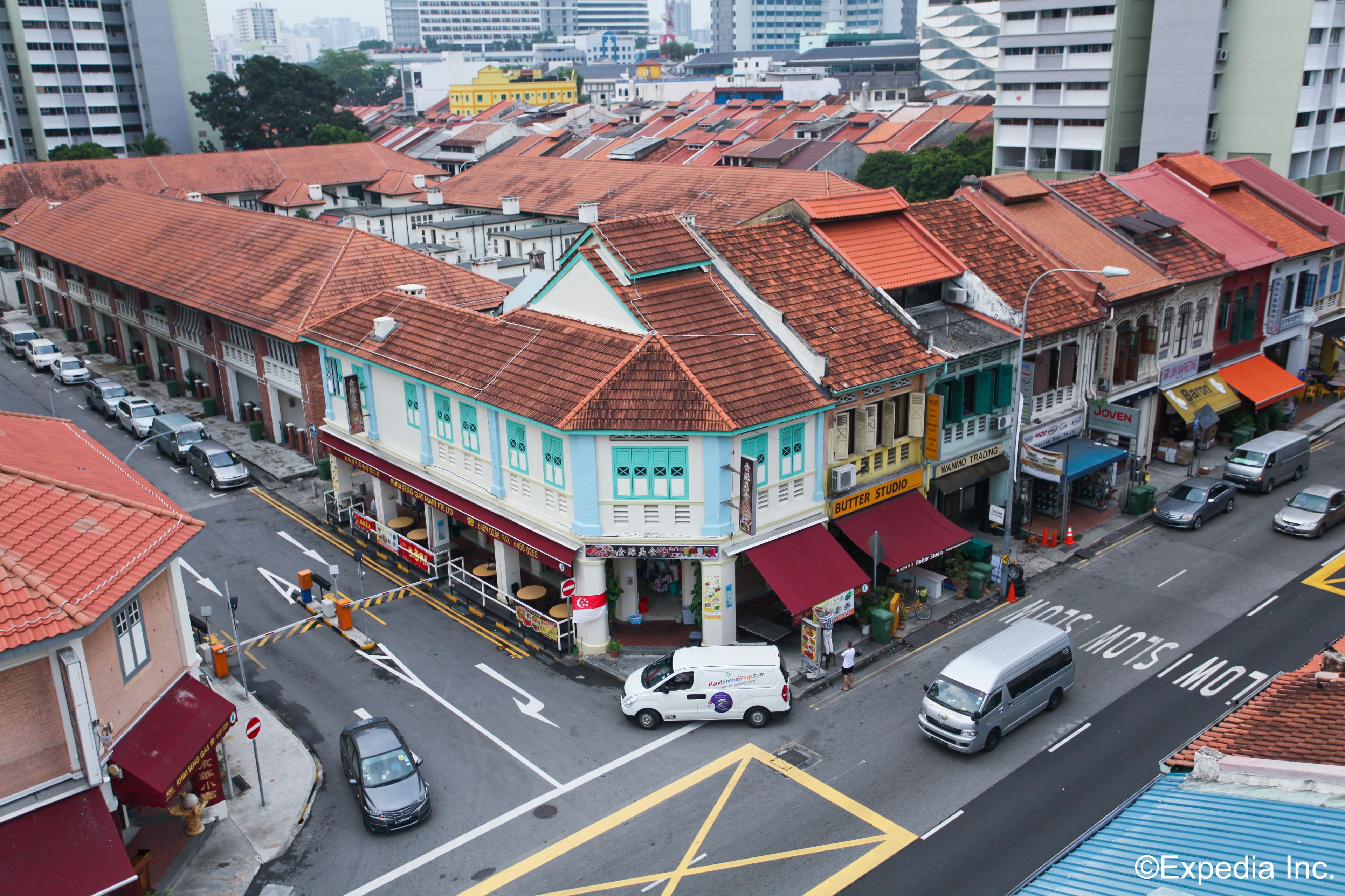 A street view of a city with buildings, cars, and a bus.