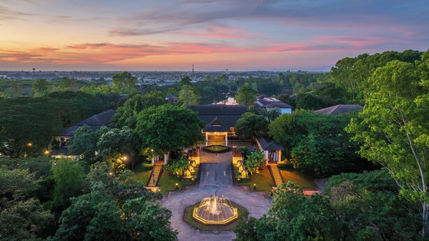 A traditional-style building with a central courtyard, surrounded by lush greenery. - Tawa Ravadee Resort, WorldHotels Distinctive (Si Maha Phot)