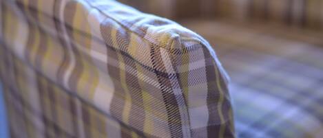 A close-up of a plaid fabric, likely part of a piece of furniture.