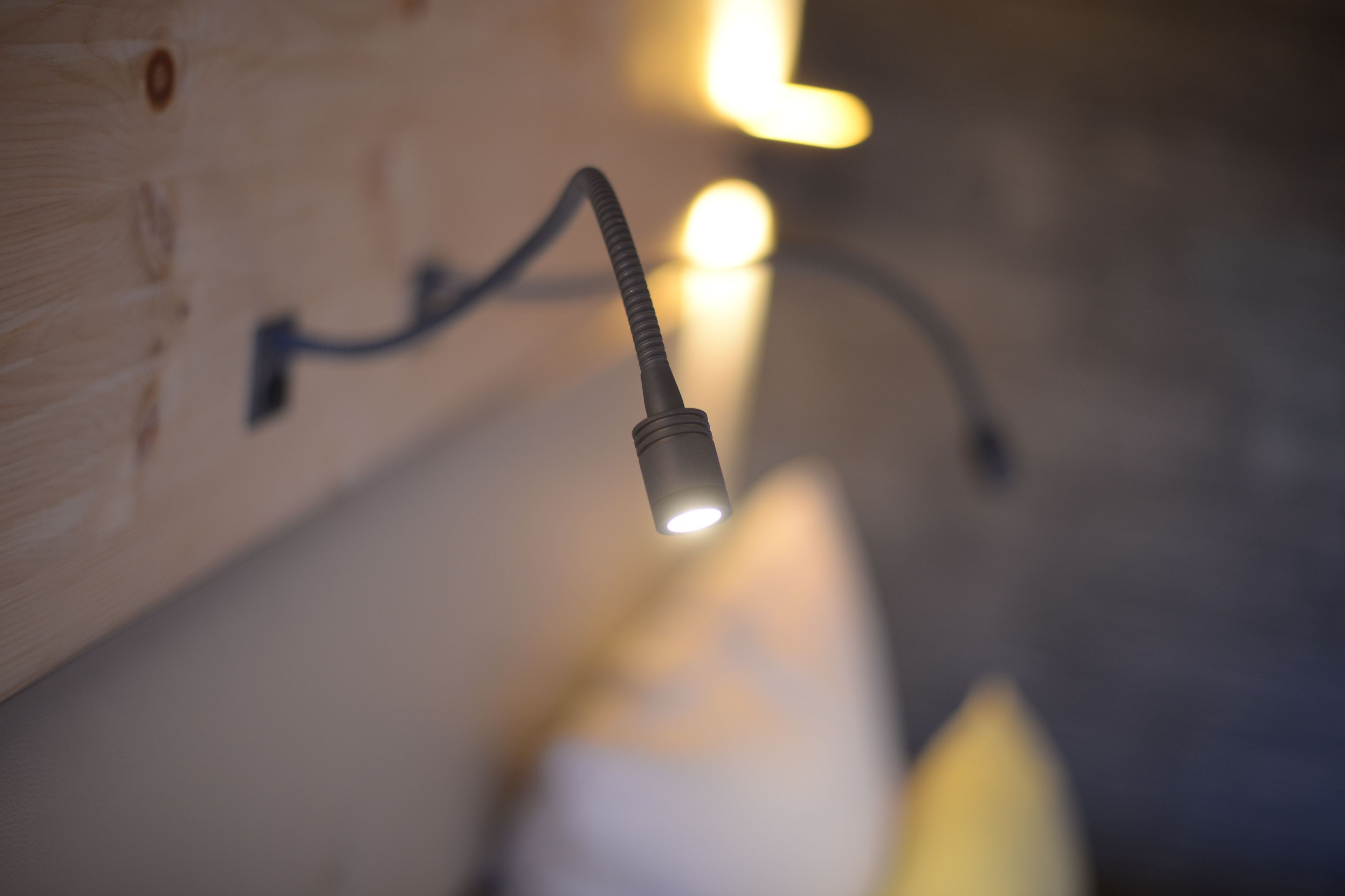 A close-up of a light fixture with a flexible cord.