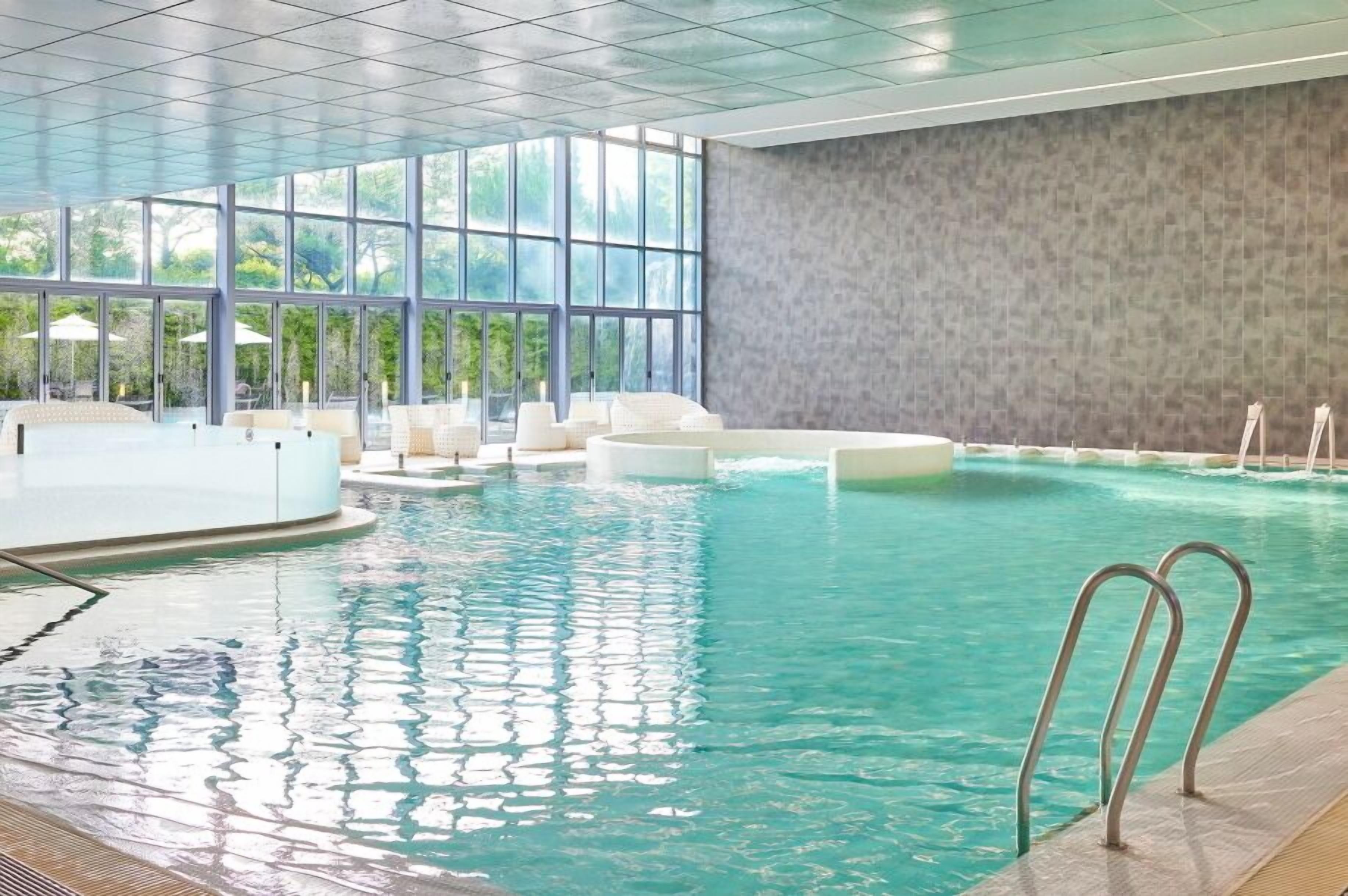 indoor pool, seasonal outdoor pool, pool umbrellas, pool loungers