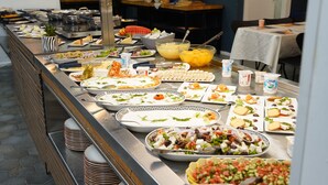A buffet with various dishes including salads, fruits, and cheeses. - Spirit of Herzl Hotel (Jerusalem)