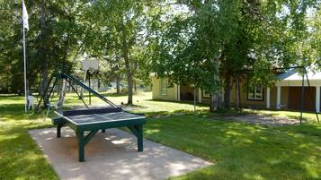 Relax and play in this serene outdoor space featuring a table tennis table and comfortable seating.