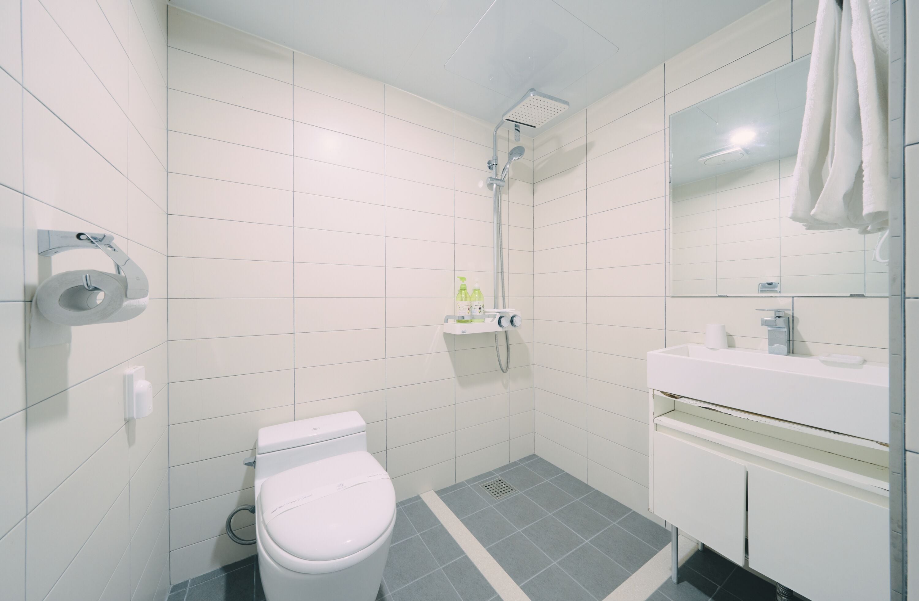 Ein modernes Badezimmer mit Toilette, Dusche und Waschbecken.