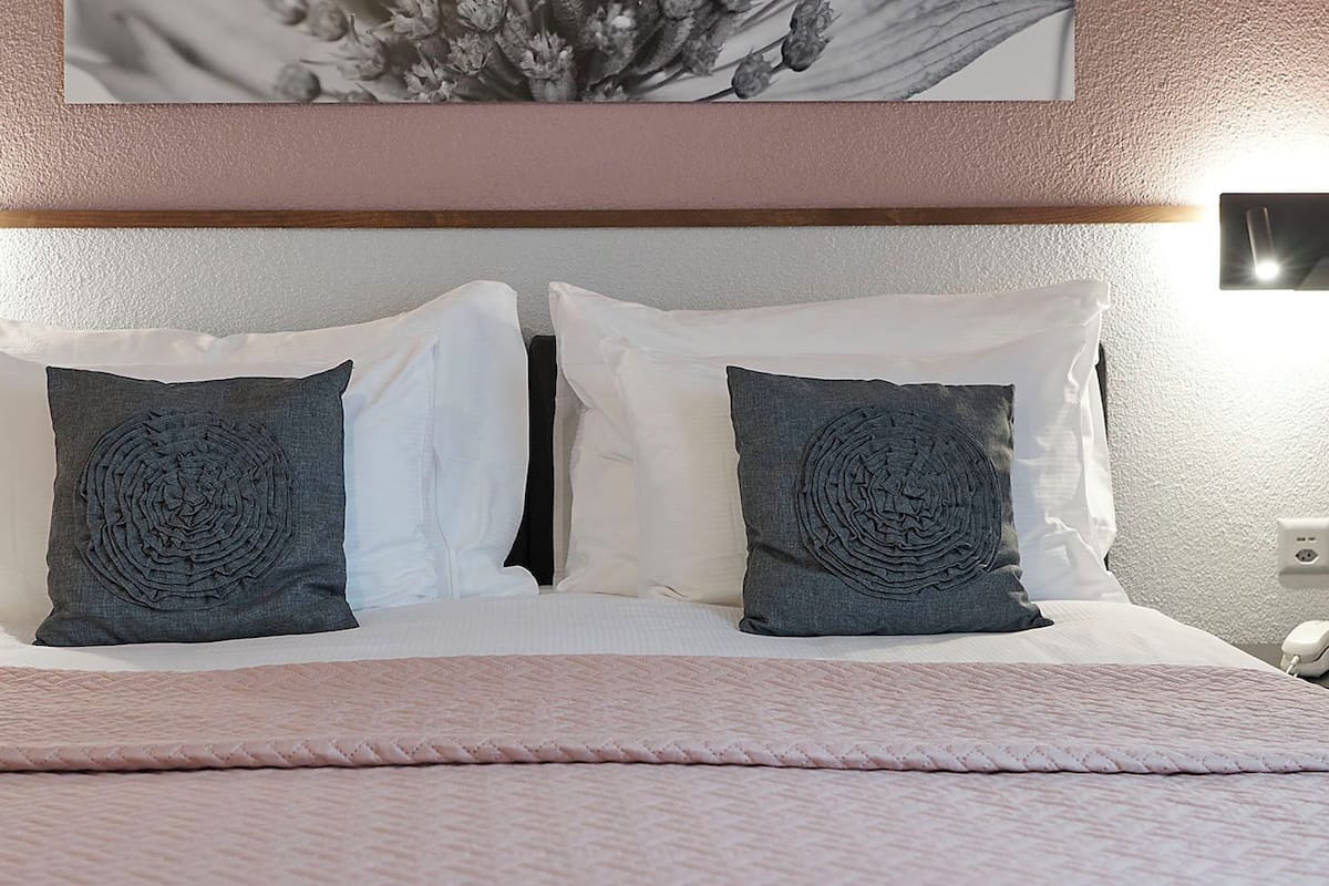 Hypo-allergenic bedding, down duvets, laptop workspace