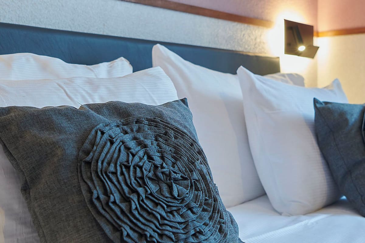 Hypo-allergenic bedding, down duvets, laptop workspace