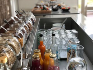 A buffet setup with various food items and beverages.