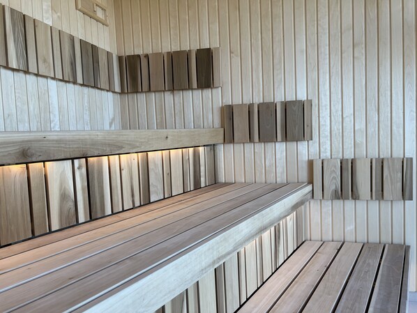 A modern interior with wooden panel walls and a bench with built-in lighting.