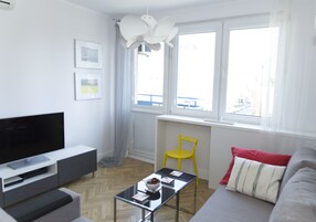 Deluxe Apartment, 1 Bedroom, Balcony, City View | Living area | Flat-screen TV