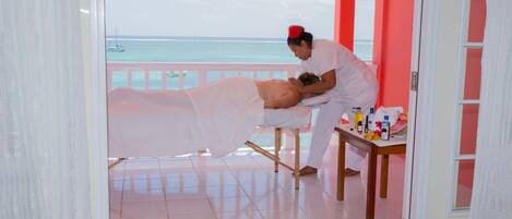 A massage therapy room with a view of the ocean.