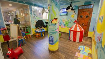 Kids can play and learn in this marine-themed play area with a whale sculpture, play mats, and a variety of toys.