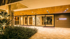 A modern building with a glass facade, a wooden ceiling, and a sign reading "The Gallery". - Sakura Terrace The Gallery (Kyoto)